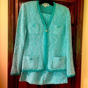 St. John knit suit. Jacket a size 8, skirt size 10z In excellent condition.
